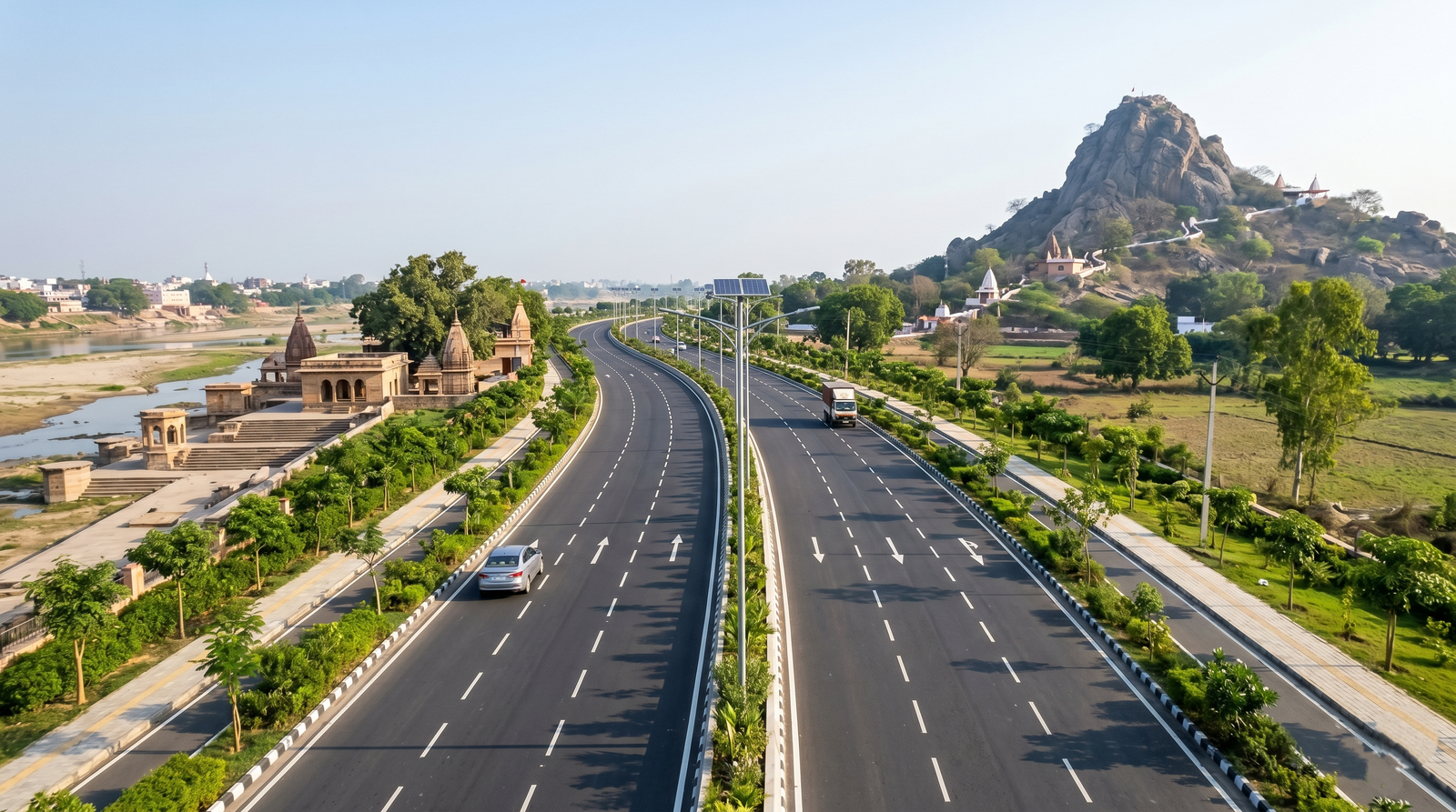 A wide four-lane asphalt bypass road under construction linking Brahmani Ghat to Pretshila Hill in Gaya Bihar under a bright blue morning sky